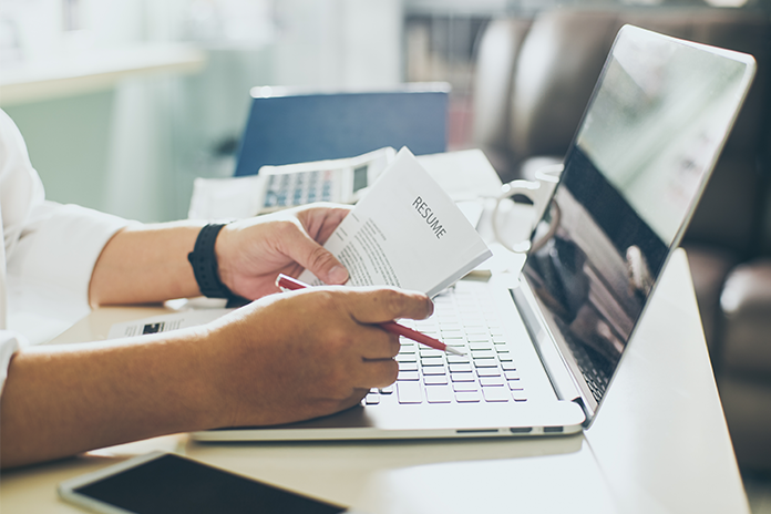 business man review his resume on desk